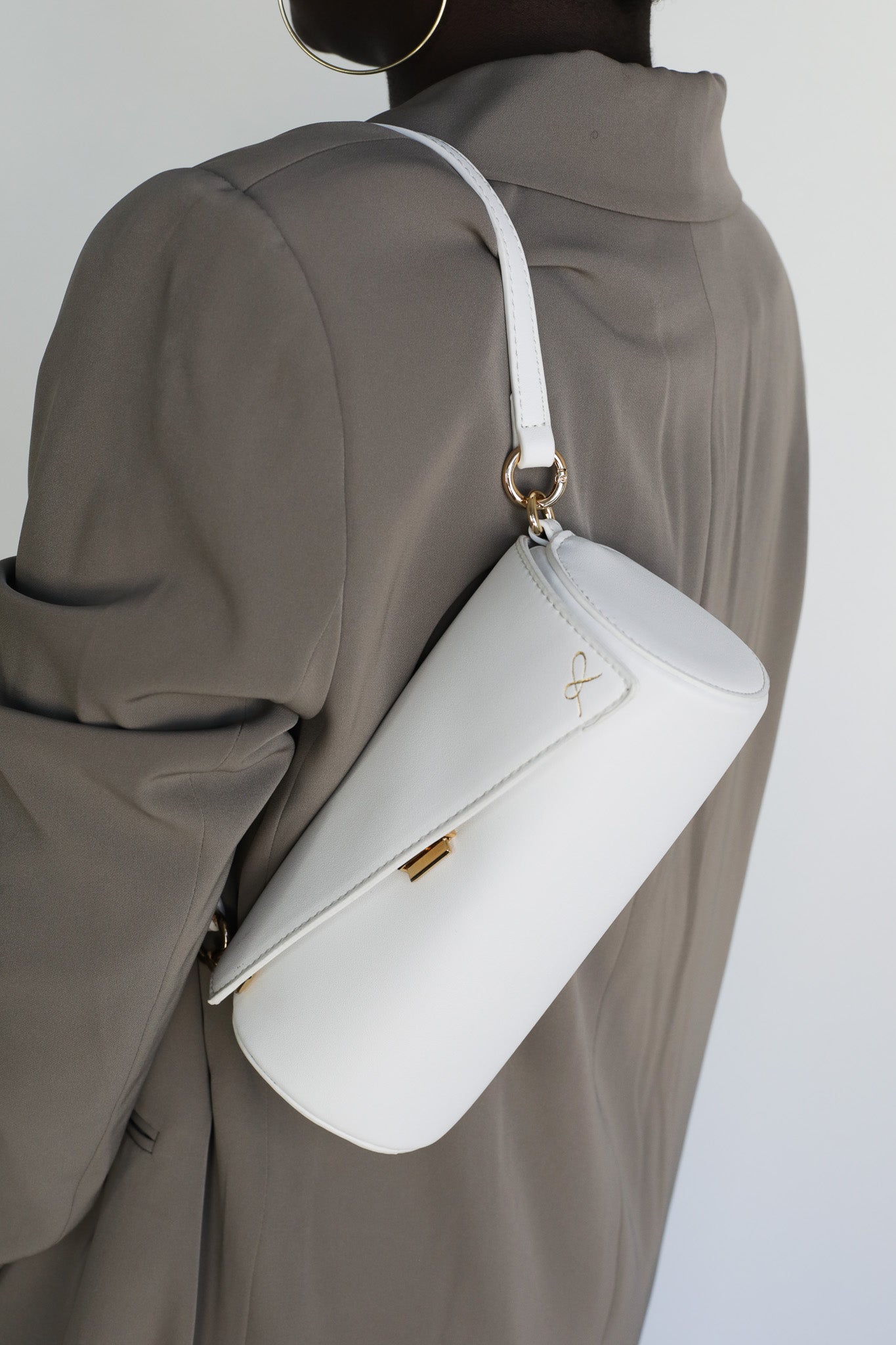 Cylinder Shaped Handbag in the color White. Bag shown with short strap