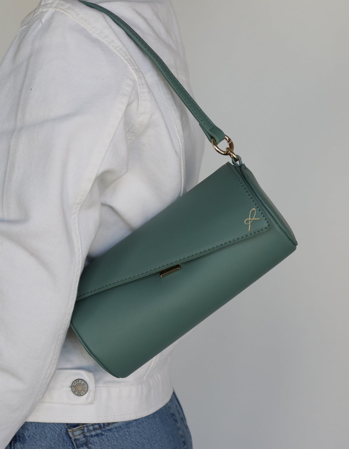 Cylinder Shaped Handbag in the color Sage. Bag shown with short strap